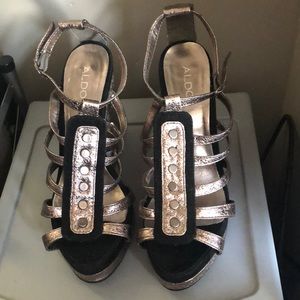 Silver metallic and black ALDO wedges.